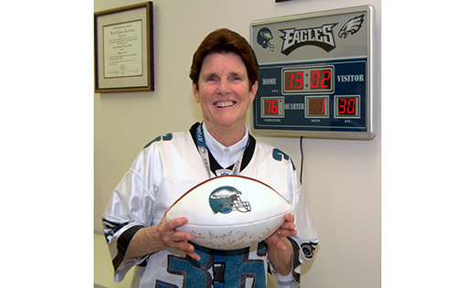 Originally from Philadelphia, Sister Margaret Fagan, principal of Epiphany School in Miami, poses with her Philadelphia Eagles jersey, a miniature scoreboard and a football autographed by former head coach Andy Reid.

CNS photo/Jim Davis for the Florida Catholic