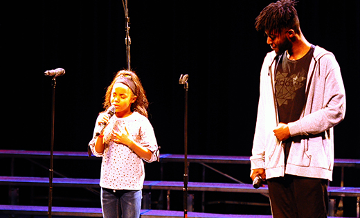 Journey Allen lifts her voice in praise, as rapper Micah Jackson looks on during last week’s Tri-State Gospel concert in Camden.

Photo by Alan M. Dumoff