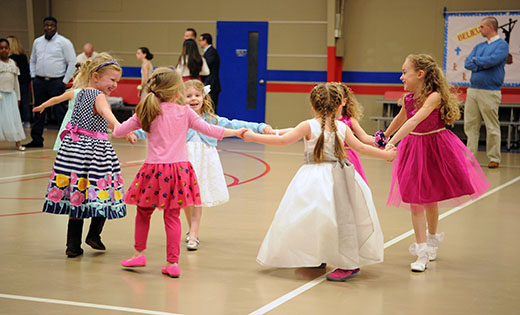 Saint Michael the Archangel School, Clayton, hosted their Daddy-Daughter dance on March 3. Above, the girls have fun on the dance floor without their fathers.
Photo by Alan M. Dumoff