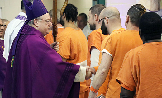 Photo by Mary McCusker
After celebrating a special Lenten Mass at Salem County Prison during Holy Week, Bishop Dennis Sullivan greets the 40 men and women who attended.