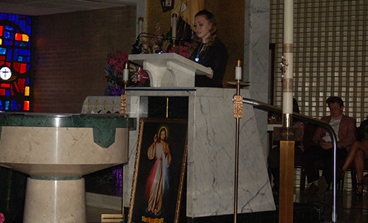 Photo by Peter G. Sánchez 
Kortnie Cinkowski, a member of the Saint Mary of Mount Carmel youth group, reads a passage from the Diary of Saint Faustina last Sunday during a Divine Mercy celebration in Hammonton.