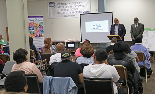 Photo by Mary McCusker

Curtis Johnson, senior housing director for Catholic Charities USA, speaks at the Free Housing and Resource Fair held at Catholic Charities’ Camden office on April 23. The event was sponsored in collaboration with the Southern New Jersey chapter of NAREB (National Association of Real Estate Brokers). Also pictured is James Andrews, director of Black Catholic Ministries and coordinator for the Racial Justice Commission, Diocese of Camden.