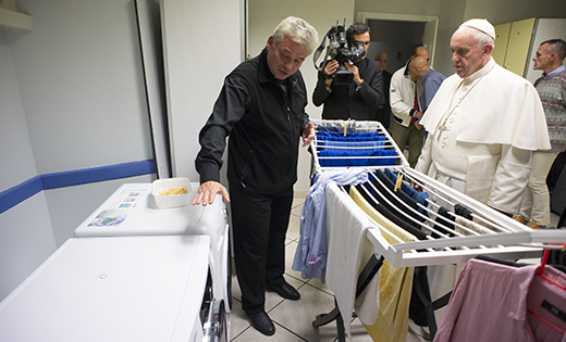 Pope Francis listens as Archbishop Konrad Krajewski, the papal almoner, offers an explanation during the pope’s visit to a new homeless shelter for men in Rome in this 2015 file photo. The Polish archbishop is one of 14 churchmen who will become cardinals June 29.

CNS photo/L’Osservatore Romano, handout