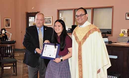 Photo by James A. McBride

Izabel Garcillano of Saint Joseph High School, Hammonton, holds the certificate she received from Cyber Liaison Officer Michael T. Vance for her winning entry in the 2017-18 New Jersey Cybersecurity Poster Contest. Also pictured is Father Allain B. Caparas, principal.