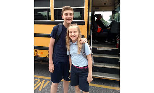 Siblings Michael and Riley Little get ready to board the bus at Our Lady of Hope School, Blackwood. When Michael heads to high school in the fall, the family will depend on three different buses.