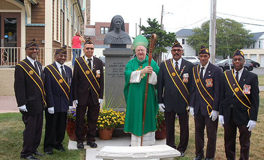 Bishop Dennis Sullivan poses for a photo with the Knights of Saint John outside the Parish of Saint Monica’s Our Lady Star of the Sea Church in Atlantic City on July 15.  Behind them is a bust of “Mother” Emma Lewis, an African-American Catholic who helped found the Saint Monica Mission in Atlantic City more than 100 years ago.

Photo by Peter G. Sánchez