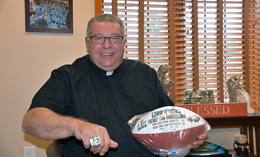 Father Thomas Barcellona, pastor of Galloway Township’s Our Lady of Perpetual Help Parish, shows off his Super Bowl bling, which he received as chaplain for the 2018 Super Bowl LII Champion Philadelphia Eagles. For the past 13 years, Father Barcellona has counseled Eagles players and staff. Made of pure 10-karat white gold, the ring includes a total of 219 diamonds and 17 rare green sapphires. There are 127 diamonds on the bezel, representing the combined jersey numbers of the three players who touched the football during the Philly Special — running back Corey Clement (30), tight end Trey Burton (88) and quarterback Nick Foles (9). Inside the ring, an underdog mask is inscribed.

Photos by James A. McBride