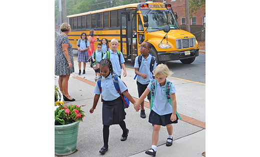 Friends hold hands as they leave the bus.

Photos by Alan M. Dumoff