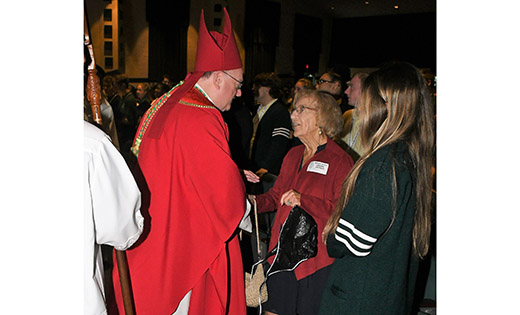 Bishop Dennis Sullivan greets Helen Brutschea, Class of 1944, after celebrating the Mass of the Holy Spirit at Camden Catholic High School, Cherry Hill, on Sept. 24. Below, the bishop accepts the offertory gifts from Faith Hardy and Kyle Hardy, Class of 2021.