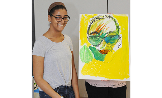 Carla Garcia-Perez (above), a student at Archbishop Damiano School, Westville Grove, stands next to the self-portrait she created during a visit to the school by Autumn de Forest, a teenage art prodigy, on Sept. 24. Below, Autumn and school principal Kathleen Flynn help Carla with her work.


Photos by Alan M. Dumoff