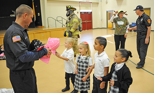 Capt. Mike Brand of the Galloway Fire Department hands out plastic firefighter hats to, from left, kindergarteners Kyle Scannell and Olivia Tunis, and first graders Troy Mathews and Aaliyah Sederholm of Assumption Regional School, Galloway, on Oct. 18.


Photo by Alan M. Dumoff