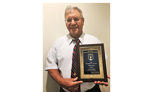 Sam Pace holds the award he received at the New Jersey Department of Corrections’ Volunteer Appreciation Day in September. Pace has worked for decades with prisoners, both as an educator and as a prison ministry volunteer.