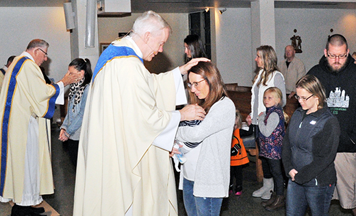— Father Michael Field, pastor of Saint Bridget University Parish, Glassboro, blesses Jamie Giambanis and her son, George, at the annual Mass in honor of Saint Gerard Majella, patron of mothers, babies and those trying to conceive. Giambanis attended last year’s Mass, when she was hoping to conceive.

Photo by Alan M. Dumoff