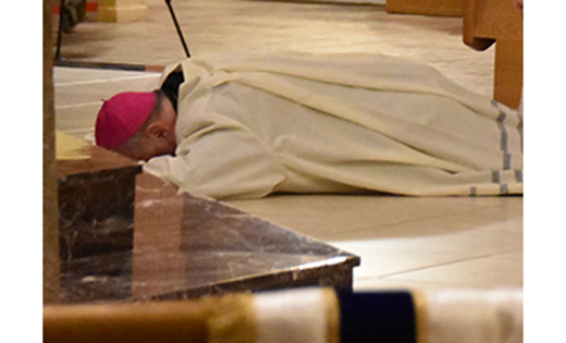In an act of penance, Bishop Dennis Sullivan lays prostrate at the beginning of a prayer service for victims of abuse and reparation for the sins of the church in Saint Agnes Church, Blackwood, on Sept. 28.

Photo by James A. McBride
