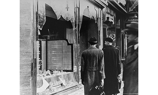 Germans pass by the broken shop window of a Jewish-owned business in Berlin that was destroyed in 1938 during Kristallnacht, or the "Night of Broken Glass." That year, from Nov. 9 to Nov. 10, Nazis in Germany torched synagogues and vandalized Jewish homes and schools.  (CNS photo/United States Holocaust Memorial Museum, courtesy National Archives and Records Administration, College Park, Md.) See CUA-KRISTALLNACHT Nov. 7, 2018.