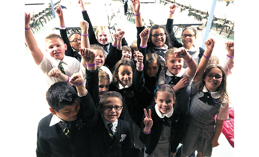 Students of Saint Peter School, Merchantville, show off their purple rubber bracelets, an Advent gift from principal Joseph Saffioti to help them remember to pray and be thankful. Throughout South Jersey Catholic Schools, communities are preparing for Christ’s birth by serving others with food, warm clothes and other necessities, toys and the gifts of music and companionship. “Helping others prepares us for Christ’s birth,” said Sophie Holliday, a sixth grader at Saint Peter.

Photos by Mary Beth Peabody