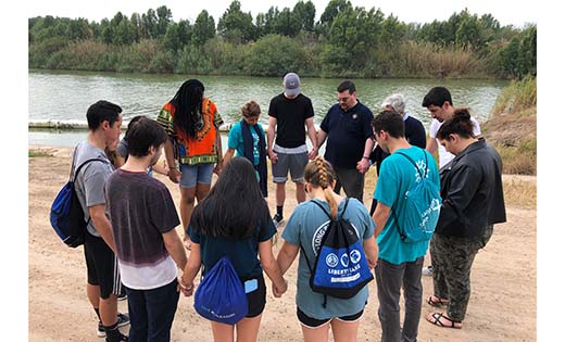 During the seventh Share the Journey Solidarity Pilgrimage to the Texas/Mexico border, missionary disciples from the Camden Diocese, including college students from Rowan, Stockton and Rutgers-Camden, gather in prayer at the Rio Grande River. They are accompanied by Sister Norma Pimentel, who oversees a humanitarian respite center in McAllen, Texas, which has provided aid to over 100,000 migrants since 2014.


Photo by Mary McCusker