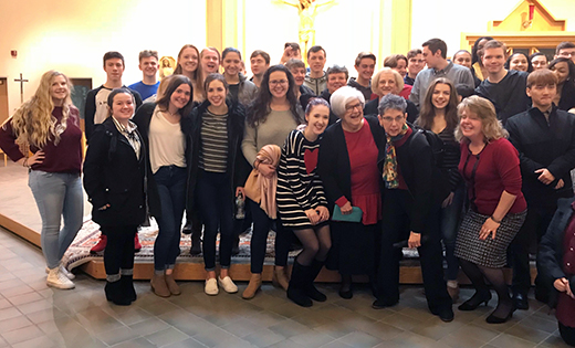 Lois Schuhl, vice principal of Saint John Paul II Regional School in Stratford, is surrounded by well-wishers during a retirement celebration shortly before Christmas. Schuhl devoted 50 years of her life to Catholic education.