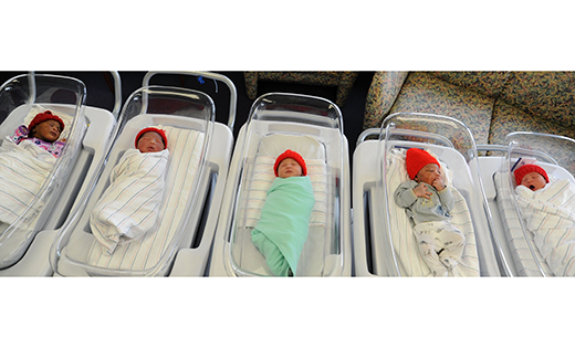 Babies recently born at Our Lady of Lourdes Medical Center wear handmade red hats provided by the American Heart Association’s Little Hats, Big Hearts program.