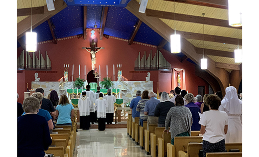Father Anthony Manuppella, pastor, helps create a holy time of prayer at Saint Gianna Beretta Molla Parish in Northfield. A series of Holy Hours is among the first fruits of the Convocation of Catholic Leaders: The Joy of the Gospel in South Jersey, that was held in Atlantic City in March.