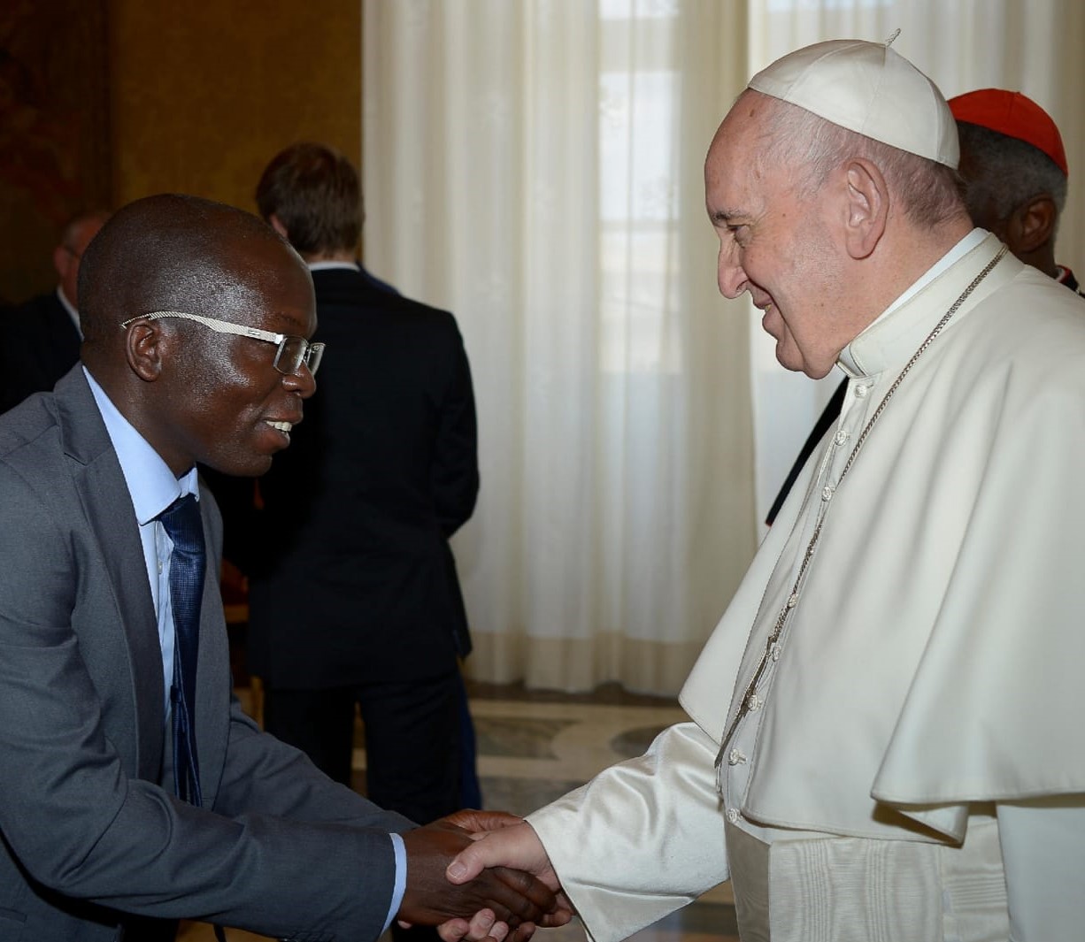 Pope Francis greets Isaias Marcano, a Mozambique native who is completing his postgraduate studies in Rome.