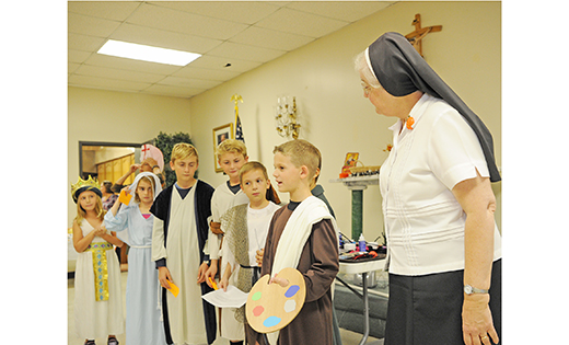 Sister Joelle Thren, SCC, director of religious education at Saint Damien Parish, Ocean City, listens as a second grader dressed as Saint Luke explains that Luke was an evangelist, an artist and a companion of Saint Paul.  Next in line is Saint Brendan the Navigator. The All Hallows’ E’en Party was held Oct. 23 for children from kindergarten through sixth grade.


Photo by Alan M. Dumoff
