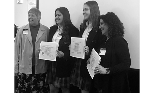 Students from Saint John Paul II Regional School in Stratford represented the Diocese of Camden at the Statehouse in Trenton on Jan. 27. The annual statewide gathering is sponsored by the New Jersey Network of Catholic School Families. It brings Catholic school students, administrators, teachers and other school community members together with lawmakers to publicly recognize the value of a Catholic school education. Students are invited to submit a project related to a theme which, for 2020, was “How Do Catholic Schools Use Technology to Solve a Local Community or Global Problem?” John Paul II students presented their work helping the Saint Vincent de Paul Food Bank increase donations, especially at times of the year when supplies may be more limited. Pictured are Sister Rose DiFluri (left), assistant superintendent of Catholic schools for the Diocese of Camden, eighth grade students Ava Borzillo and Emily Monforto, and Saint John Paul II STEM teacher, Danielle Hurd.