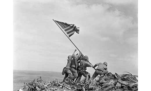 Public Domain
Photographer Joe Rosenthal captured the image of Marines raising the American flag atop Mount Suribachi during the Battle of Iwo Jima in the final stages of the Pacific War in 1945.