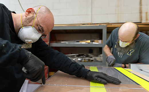 Seth Pearlman, left, and Bob Loch remove excess plexiglass from the area of the sheet that will be heated up and bent, at Ascalon Studios in Berlin, NJ on Monday, April 6, 2020.

[DAVE HERNANDEZ / PHOTOJOURNALIST]