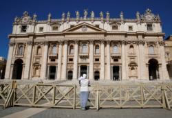 A nun prays in a deserted St. Peter's Square as Pope Francis holds the weekly general audience virtually in the library of the Apostolic Palace at the Vatican May 27, 2020. (CNS photo/Remo Casilli, Reuters) See POPE-AUDIENCE-PRAYER-POWER May 27, 2020.