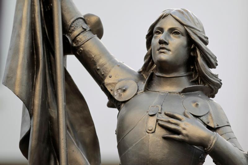 A statue of St. Joan of Arc is seen in the courtyard of the headquarters of the National Front political party in Nanterre, France, in this 2012 photo. This year, the Catholic Church celebrates the 100th anniversary of the canonization of St. Joan of Arc, whose image transcends political divisions. (CNS photo/Charles Platiau, Reuters) See JOAN-OF-ARC June 29, 2020.