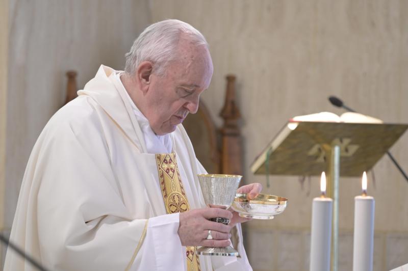 Pope Francis celebrates Mass in the chapel of his residence, the Domus Sanctae Marthae, at the Vatican July 8, 2020. He was marking the seventh anniversary of his first trip as pope to the island of Lampedusa, where thousands of migrants head each year seeking a better life in Europe. (CNS photo/Vatican Media)