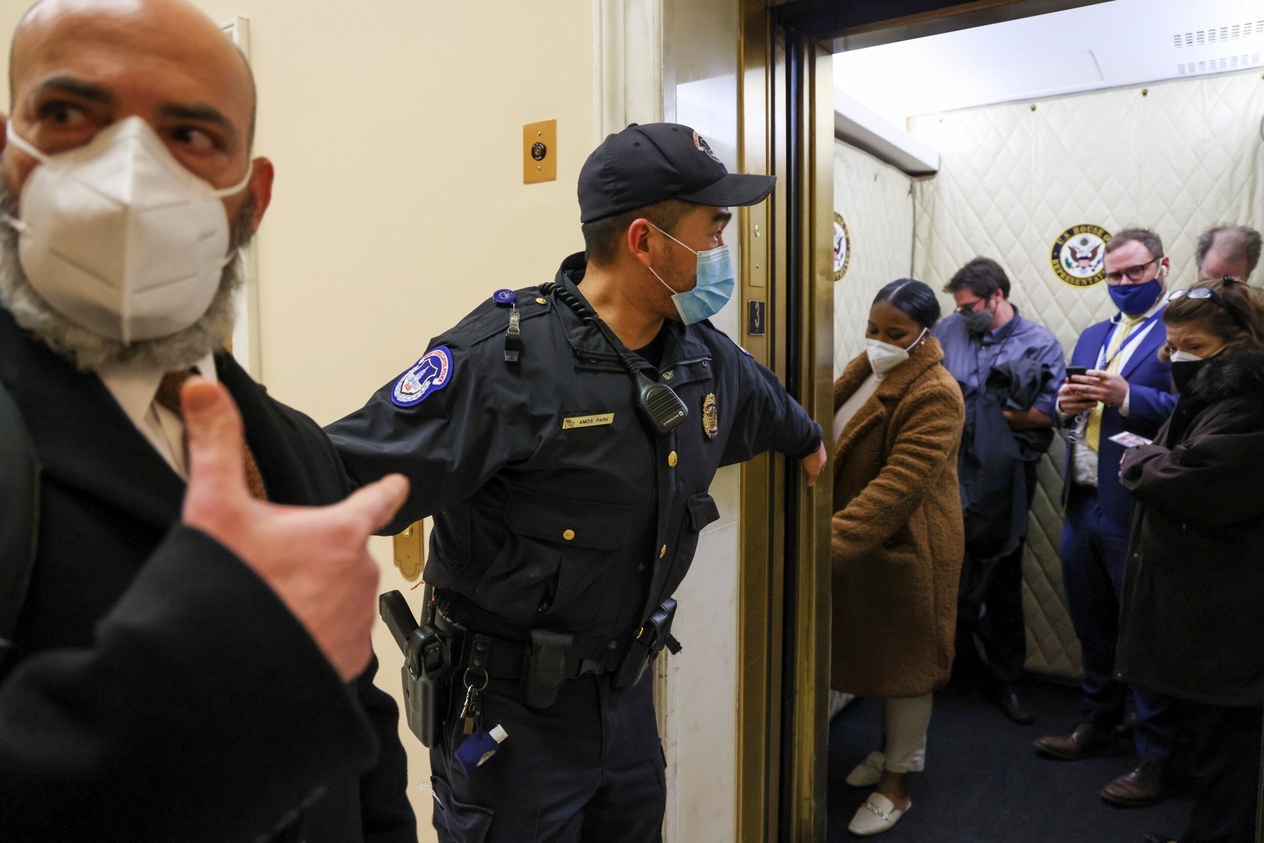 Capitol police officers evacuate journalists and House press staff members from the U.S. Capitol building in Washington Jan. 6, 2021, after supporters of President Donald Trump breached security defenses. (CNS photo/Jonathan Ernst, Reuters)
