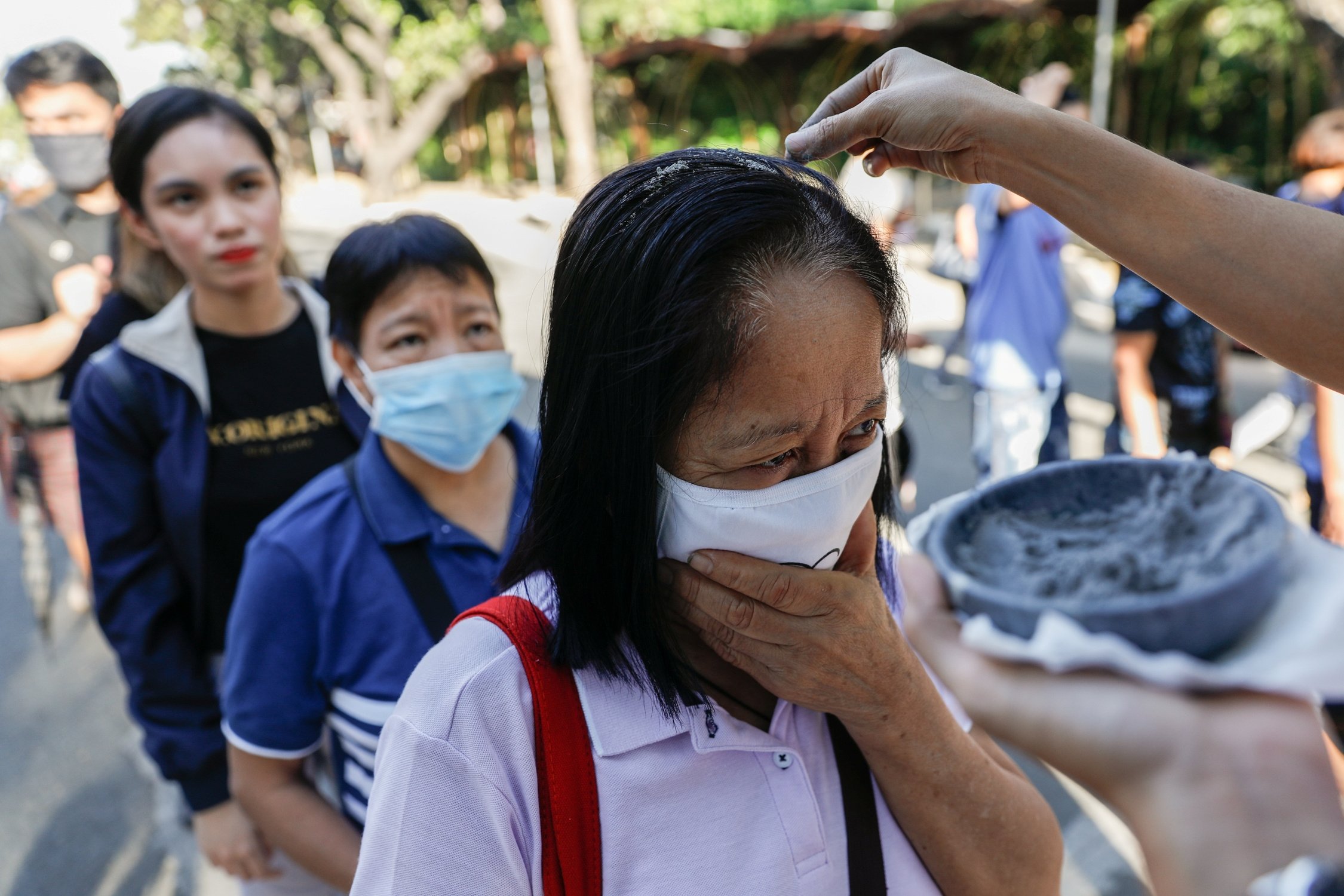 Worshippers wearing protective masks receive ashes during Ash Wednesday Mass at the National Shrine of Our Mother of Perpetual Help in Manila, Philippines, Feb. 26, 2020, during the COVID-19 pandemic. The Vatican Congregation for Divine Worship and the Sacraments has issued a note on how priests can distribute ashes on Ash Wednesday while taking precautions to avoid spreading COVID-19. (CNS photo/Eloisa Lopez, Reuters)