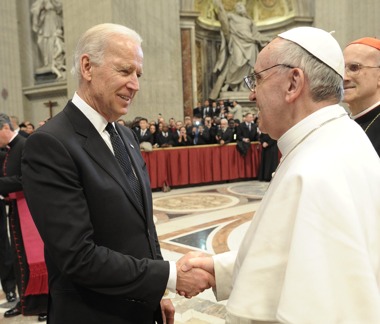 Pope Francis greets U.S. Vice President Joe Biden in St. Peter's Basilica at the Vatican March 19, 2013, as the new pontiff receives dignitaries following his inaugural Mass. The pope sent a written message to Biden upon his Jan. 20 inauguration as president of the United States. (CNS photo/Vatican Media)