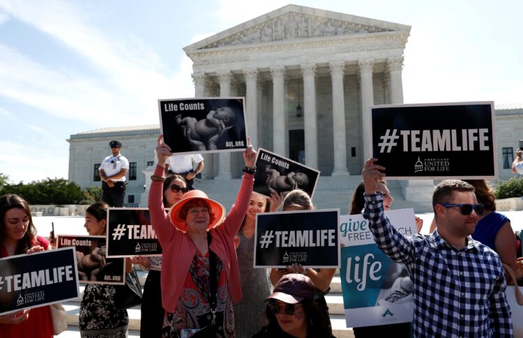 Pro-life demonstrators are seen outside the Supreme Court in Washington June 26, 2018. (CNS photo/Leah Millis, Reuters)