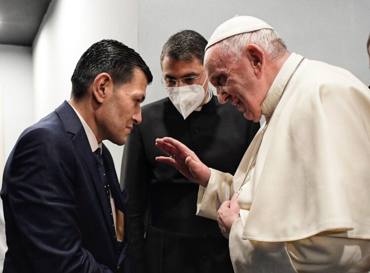 Pope Francis meets Abdullah Kurdi, the father of 3-year old Aylan Kurdi whose body washed up on a Turkish beach in 2015, at the conclusion of the Mass at the stadium in Irbil, Iraq, March 7, 2021. Kurdi lost his wife, Aylan and another son in a shipwreck as the Syrian family was trying to reach Europe. (CNS photo/Vatican Media)