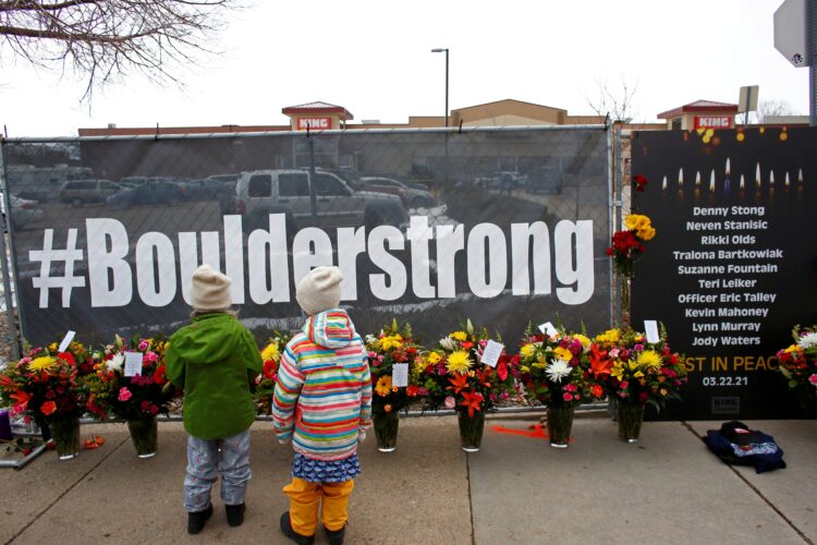 People leave flowers at King Soopers grocery store in Boulder, Colo., March 23, 2021, the site of a mass shooting that killed 10 people the previous day. (CNS photo/Kevin Mohatt, Reuters)