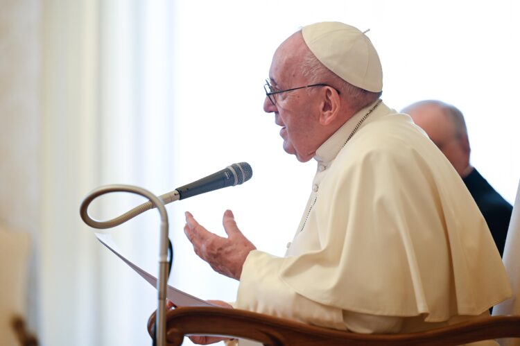 Pope Francis leads his general audience in the library of the Apostolic Palace at the Vatican April 7, 2021. The pope said Christians are never alone in prayer but instead are accompanied by countless saints who have preceded them. (CNS photo/Vatican Media)