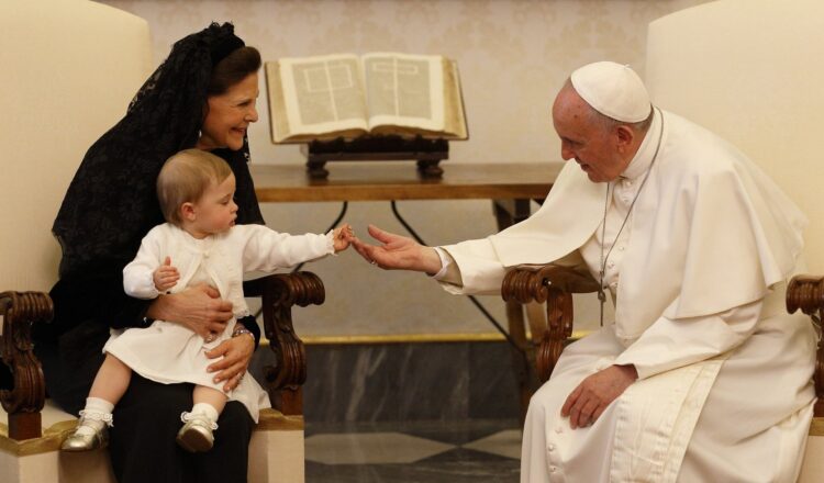 Princess Leonore, held by Sweden's Queen Silvia, gives a papal key chain to Pope Francis during her grandmother's private audience with Pope Francis in the Apostolic Palace at the Vatican in this April 27, 2015, file photo. The pope has chosen the theme, "I am with you always," for the first World Day for Grandparents and the Elderly, which will be celebrated July 25, 2021. (CNS photo/Paul Haring)