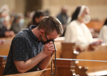 A man prays the rosary at the Basilica of the National Shrine of the Immaculate Conception in Washington May 17, 2021. The rosary, led by Washington Cardinal Wilton D. Gregory, was part of a worldwide effort called by Pope Francis to pray for an end to the coronavirus pandemic. (CNS photo/Andrew Biraj, Catholic Standard)