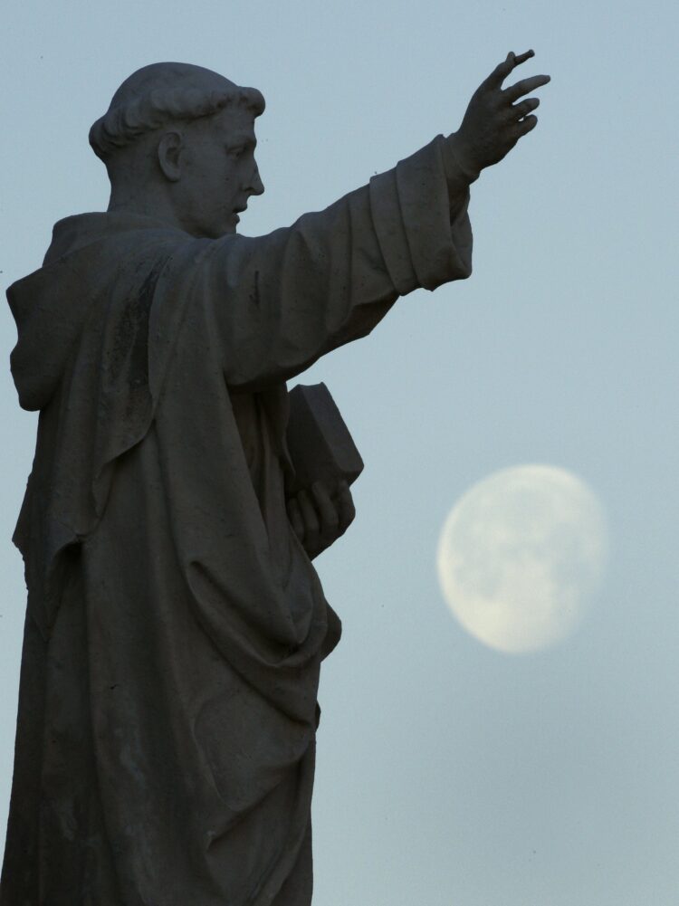 The moon is seen near a statue of St. Dominic outside the Dominican House of Studies in Washington in this Feb. 12, 2009, file photo. In a message commemorating the 800th anniversary of the death of St. Dominic, Pope Francis said the life of the Spanish saint and his zeal for preaching the Gospel serve "as an inspiration to all the baptized." (CNS photo/Bob Roller)