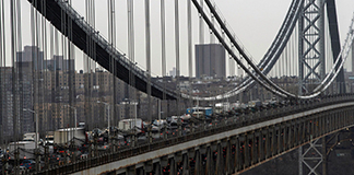 The George Washington Bridge is seen from Fort Lee Historic Park, N.J., March 31, 2021. In a speech in Pittsburgh that same day, President Joe Biden laid out his proposed $2.2 trillion infrastructure package, with funding for broadband, housing, the electric grid, roads and bridges, and other areas. It will raise taxes on corporations and wealthy Americans to pay for its spending priorities. (CNS photo/Eduardo Munoz, Reuters)