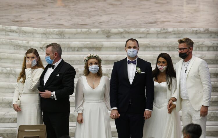 Newly married couples wait to meet Pope Francis during his general audience in Paul VI hall at the Vatican in this Oct. 7, 2020, file photo. In his prayer intention for the month of June, the pope prayed for young couples who answer the vocational call to marriage, which is "a challenging journey, at times difficult, sometimes even confrontational, but it is worth the risk." (CNS photo/Paul Haring)