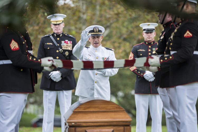 Father Eduardo B. Amora, a Navy chaplain who holds the rank of lieutenant commander, gives remarks Sept. 27, 2018, at Arlington National Cemetery during the group burial of four Marines and one sailor who died during the Vietnam War. Buried in Section 60 of the cemetery, their remains were identified decades after their deaths by the Defense POW/MIA Accounting Agency. Father Amora is a priest of the Diocese of Mati, Philippines, on assignment with the U.S. Archdiocese for the Military Services. (CNS photo/Elizabeth Fraser, courtesy Arlington National Cemetery via Arlington Catholic Herald)