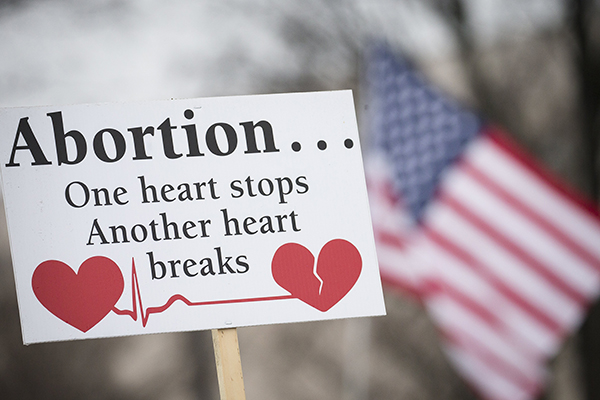 A pro-life sign is displayed during the 2019 annual March for Life rally in Washington. In Idaho, the Legislature approved a measure April 20, 2021, to ban abortion once a fetal heartbeat is detected and it was sent to Gov. Brad Little. (CNS photo/Tyler Orsburn)