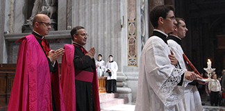Msgr. Peter B. Wells, left, a U.S. priest who works at the Vatican Secretariat of State, leaves a Tridentine-rite Mass celebrated at the Altar of the Chair in St. Peter's Basilica at the Vatican May 15, 2011. (CNS photo/Paul Haring)