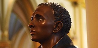 This statue of St. Martin de Porres appears to stand watch at the entrance of St. Augustine Church in Washington July 25, 2019. (CNS photo/Elizabeth Bachmann) See WASHINGTON-RELIGIOUS-SITES Aug. 1, 2019.