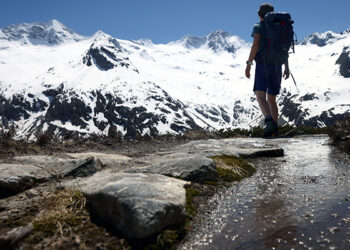A hiker is seen in front of snow-covered mountains in the Zillertal Alps, near the village of Ginzling, Austria, June 1, 2021. (CNS photo/Lisi Niesner, Reuters)