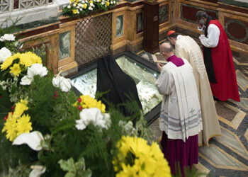 Romanian Orthodox Bishop Atanasie Rusnac, vicar for the Diocese of Italy, Cardinal Kurt Koch, president of the Pontifical Council for Promoting Christian Unity, and Anglican Archbishop Ian Ernest, director of the Anglican Centre in Rome, pray at the tomb of St. Paul during vespers to close the Week of Prayer for Christian Unity, at the Basilica of St. Paul Outside the Walls in Rome Jan. 25, 2021. (CNS photo/Vatican Media)